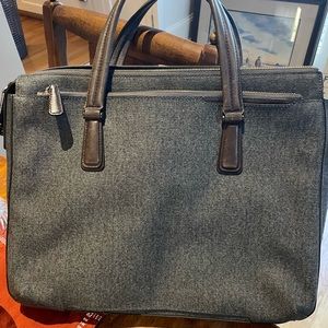 Tumi woman’s laptop bag, lim bag, lots of pockets, slides onto luggage handle